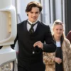 Louis Partridge House of Guinness Black Coat